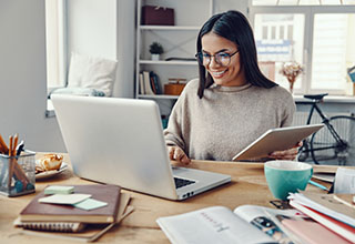 Woman sitting at laptop working from home