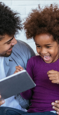 Man & child on tablet