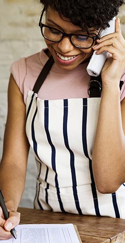 Woman in apron taking phone order